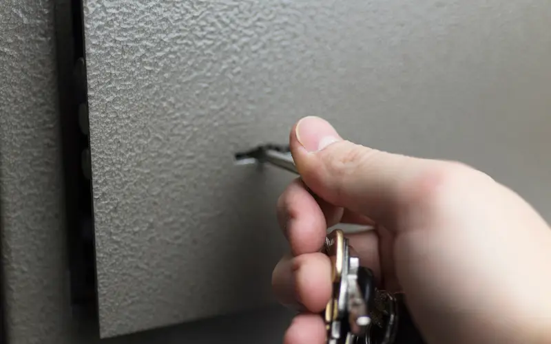 A person inserts a key into a lock.