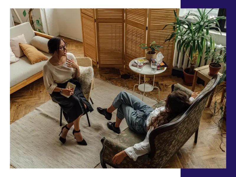 A therapist talking with a woman in therapy, looking from an overhead view.