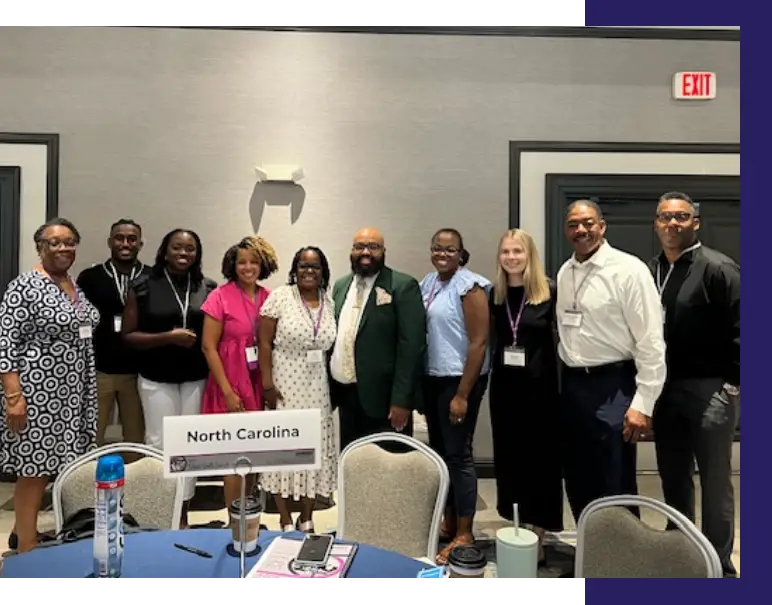 A diverse group of people at an event from the North Carolina Black Youth Suicide Prevention Leadership Team.