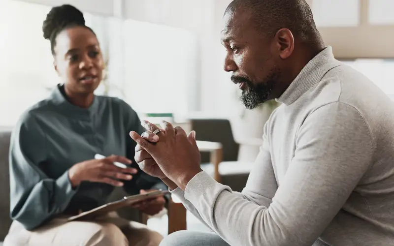 A Black man talks to a Black therapist.